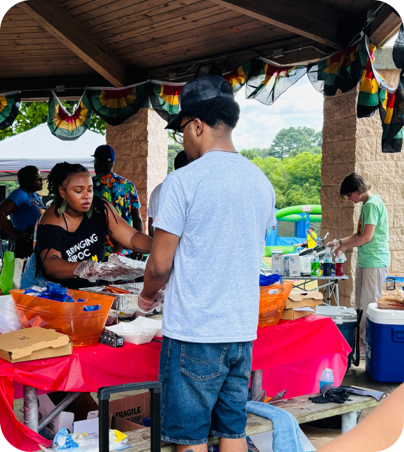 Black man being served food at a GAPS event.